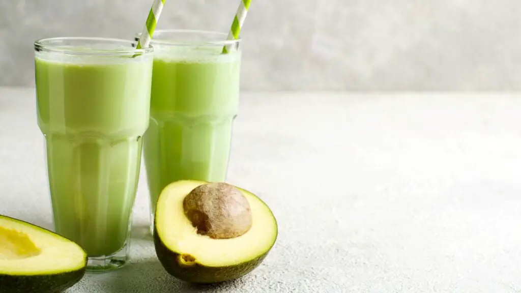 Two avocado pieces and two avocado juice glasses