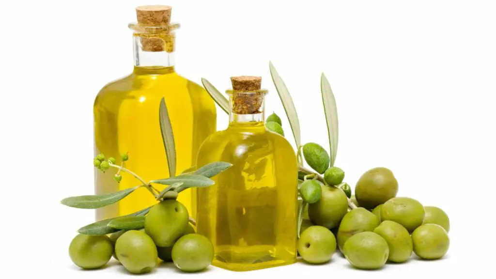 Two virgin olive oil bottles and a bunch of olives