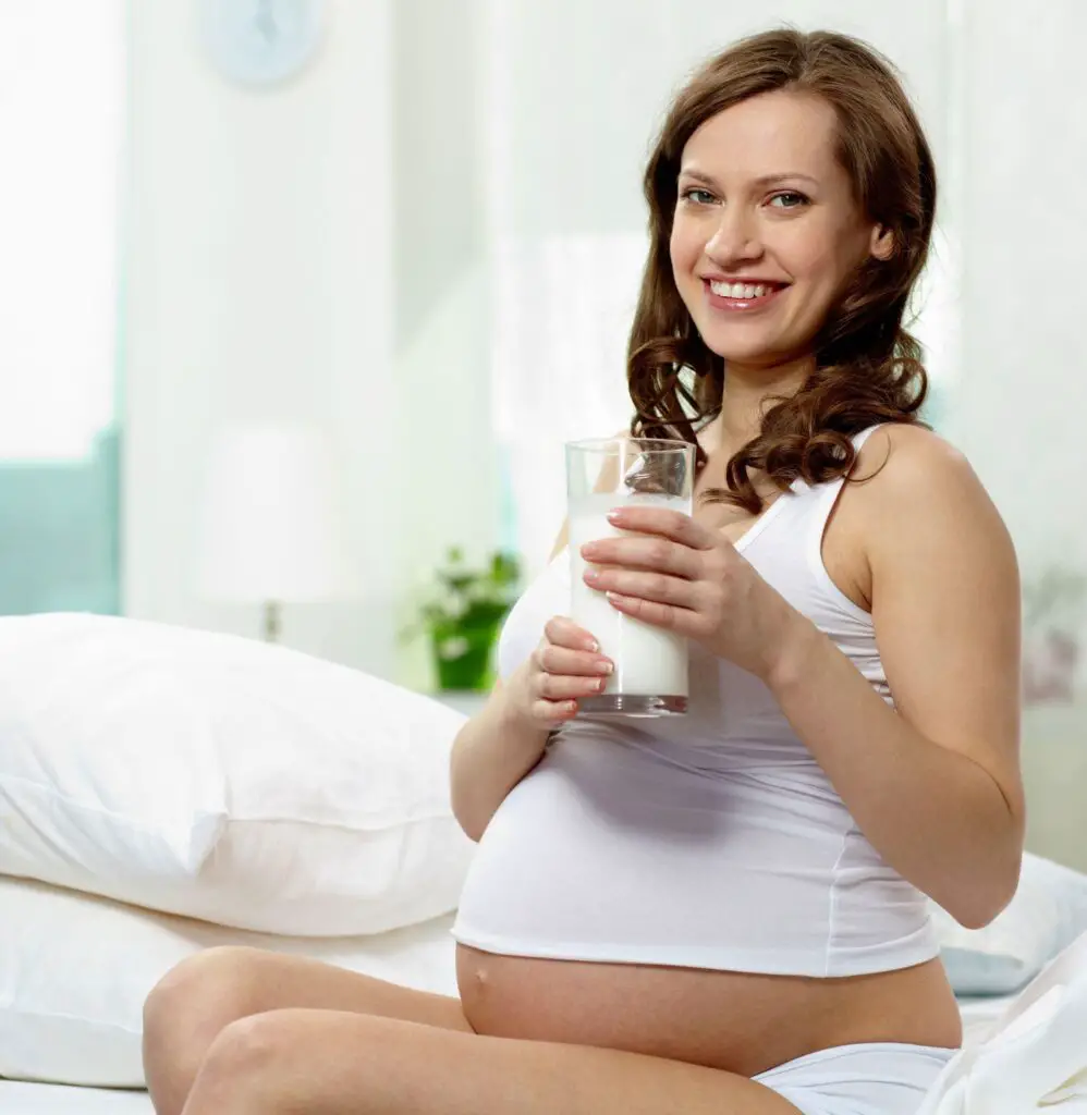 Pregnant mother with milk glass