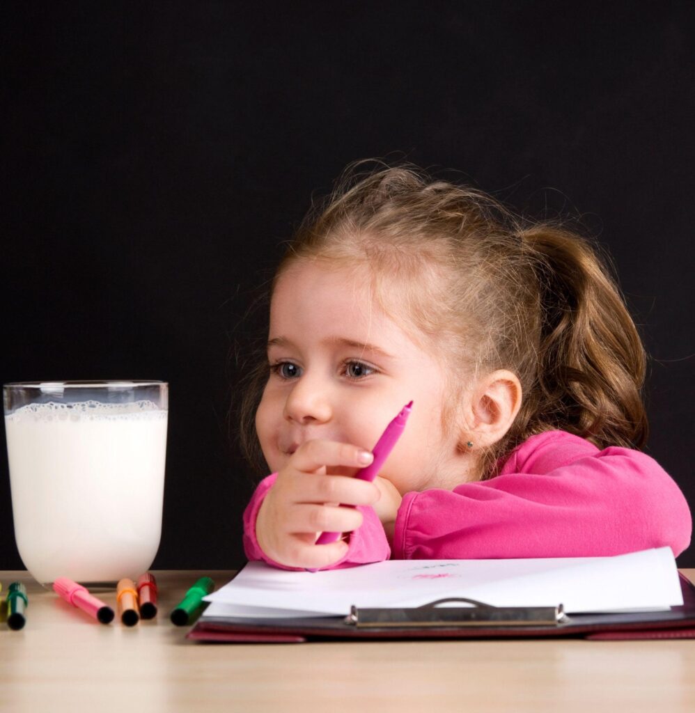 Girl with book and milk glass