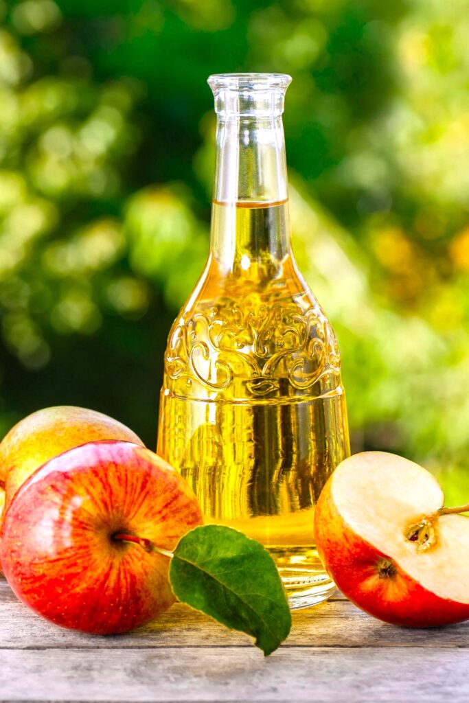Apple cider vinegar bottle and apples