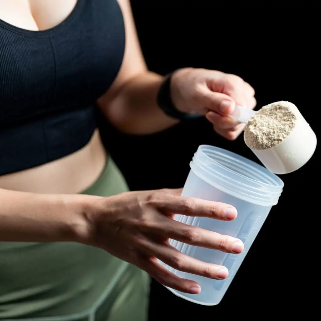 Girl filling protein powder to cup