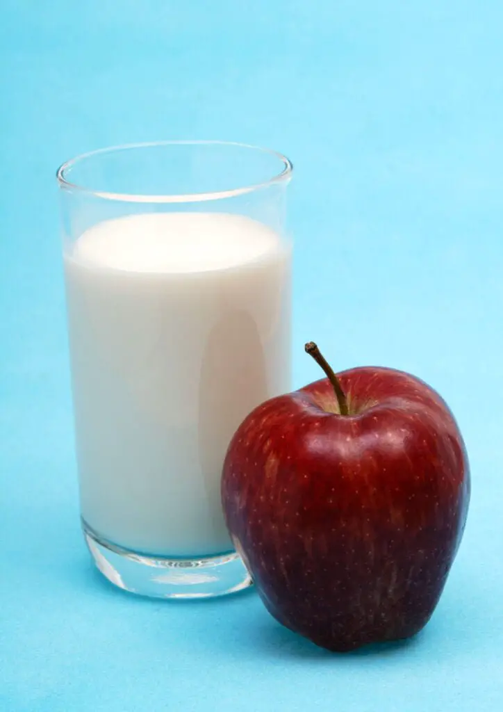 Milk glass and apple