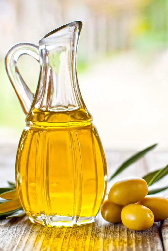 Olive oil jug and olives
