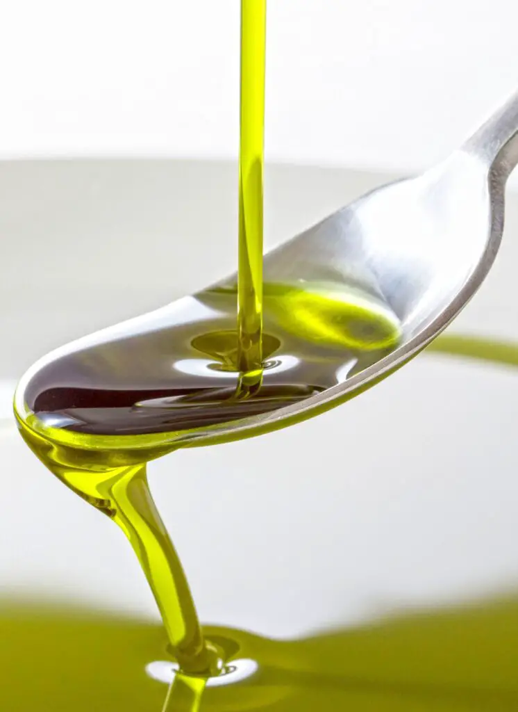 Olive oil pouring to spoon