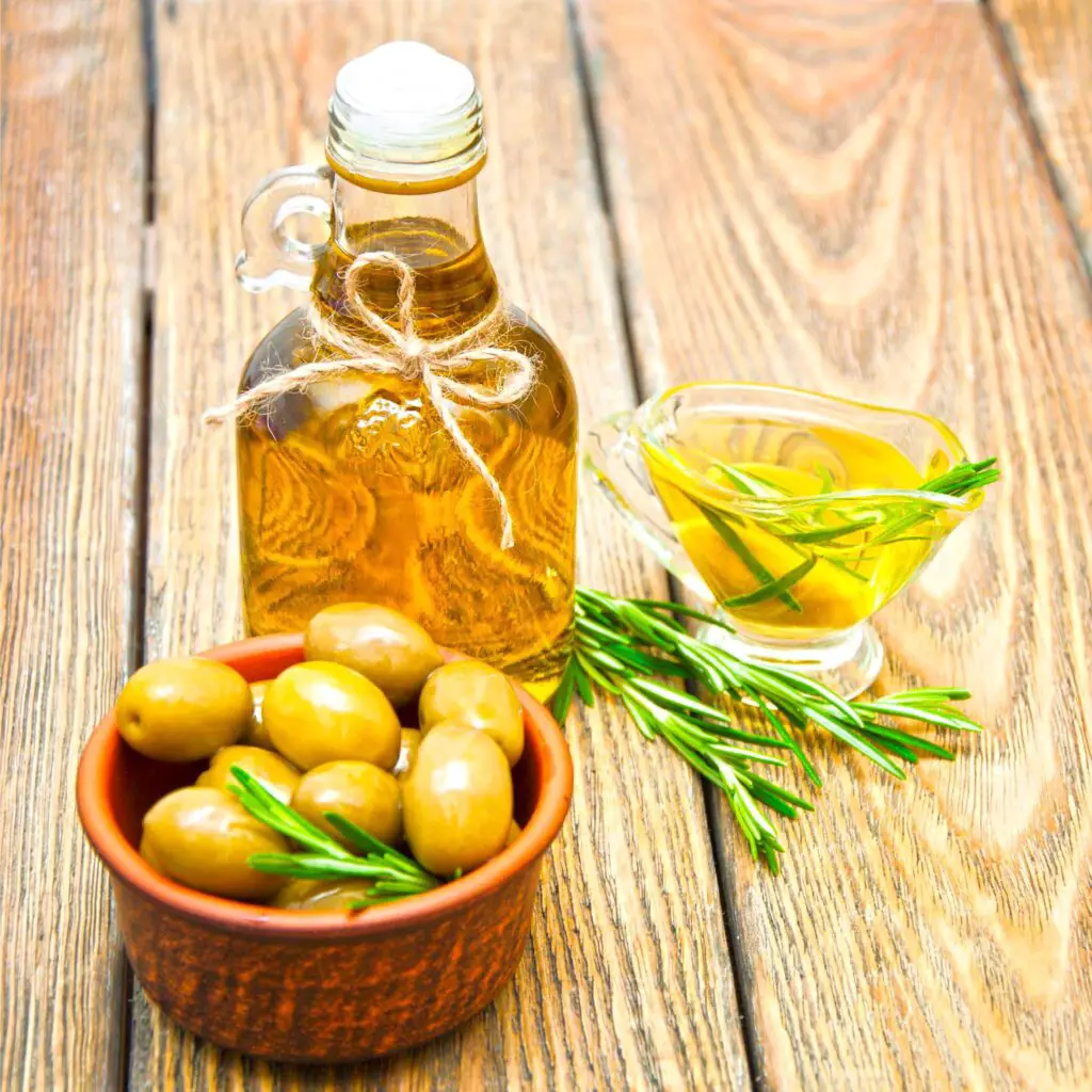 Olive oil bottle and olivs