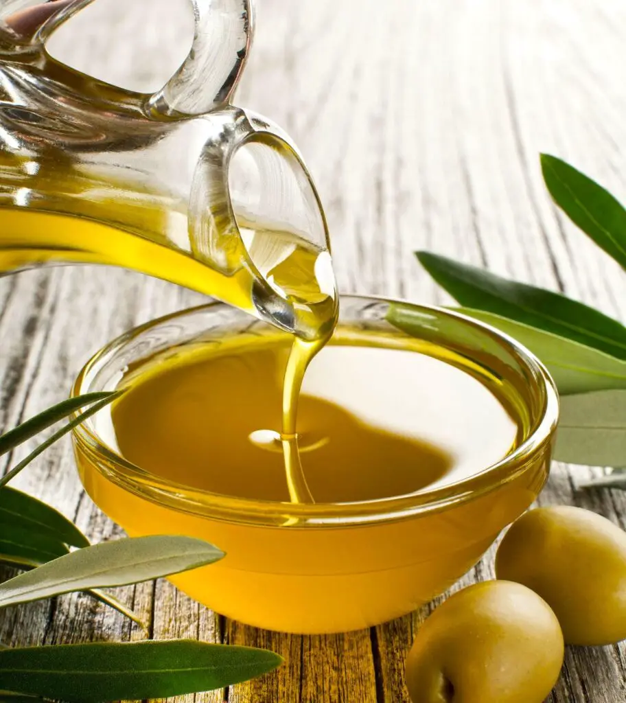 Olive oil pouring to bowl