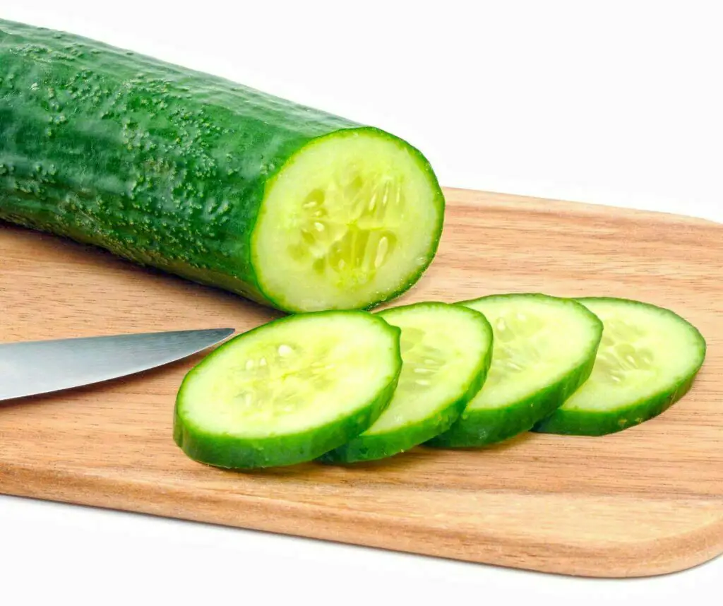 Cucumber and pieces on chopping board