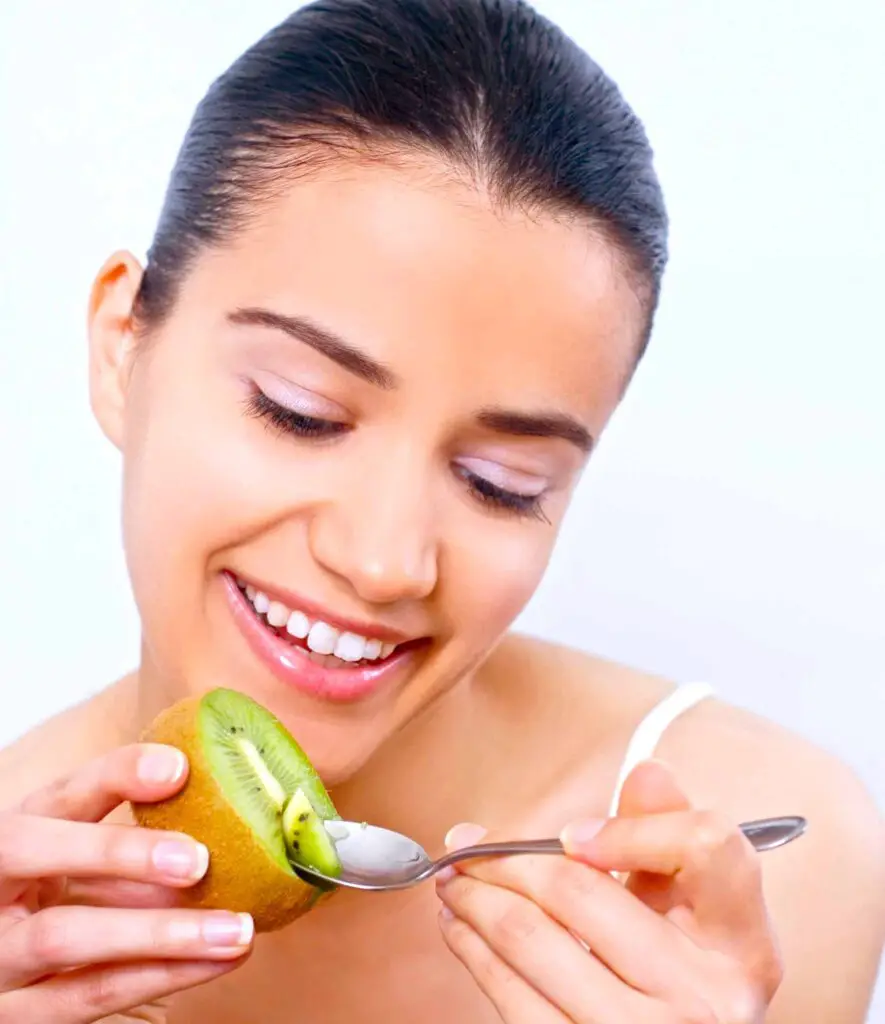 Girl eating kiwi