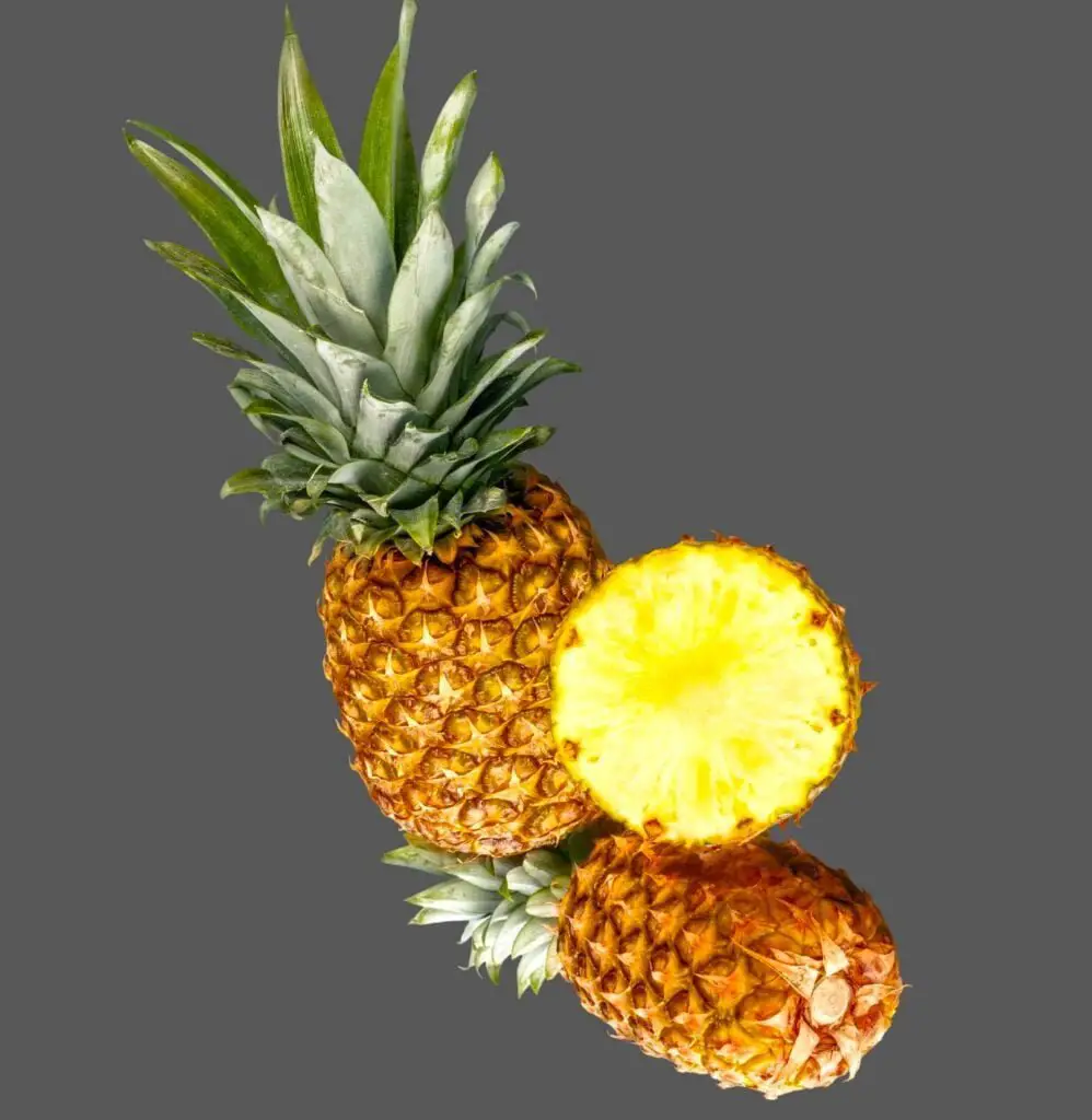 Two pineapples and slice