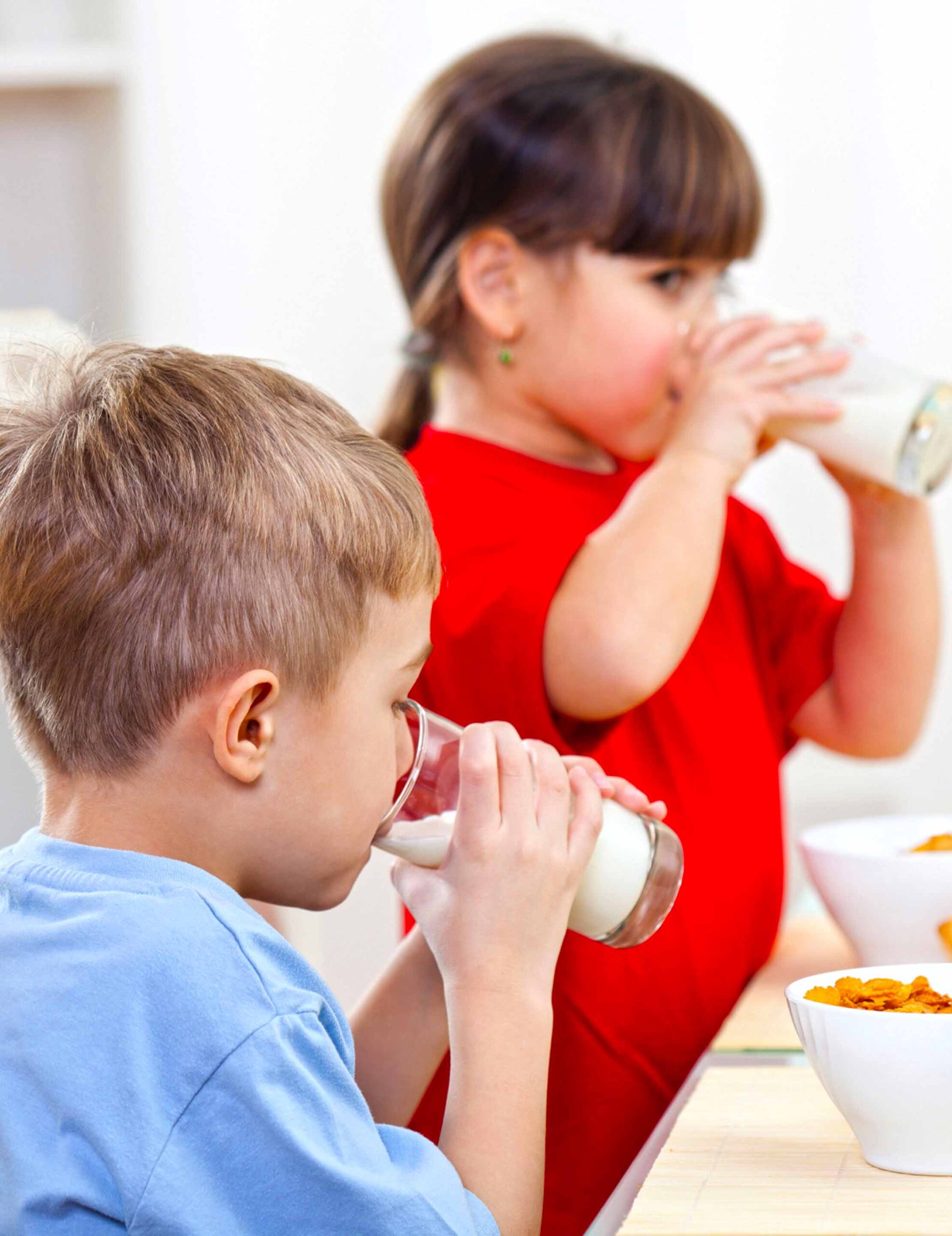 Boy and girl drinking milk