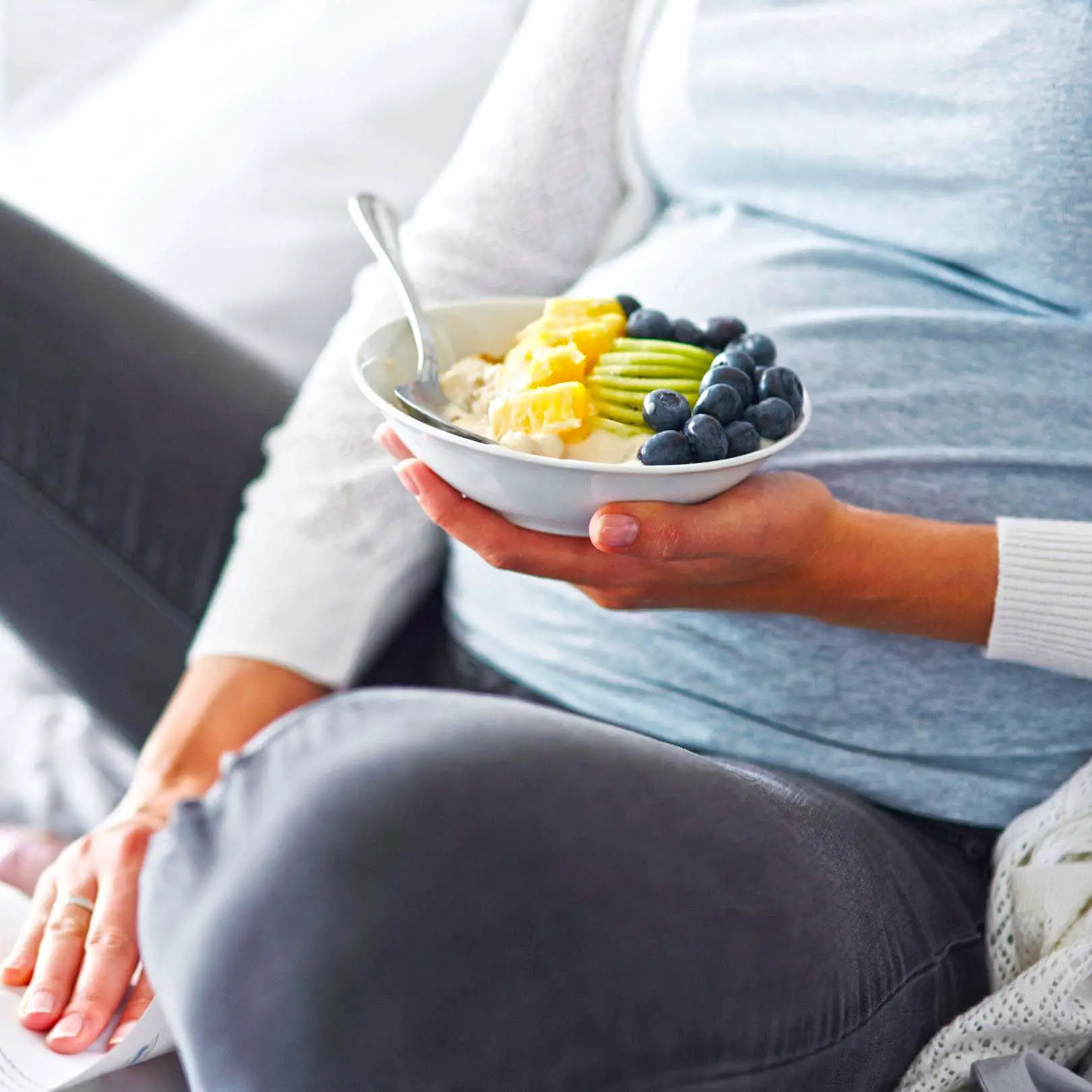 Pregnant woman eating yogurt